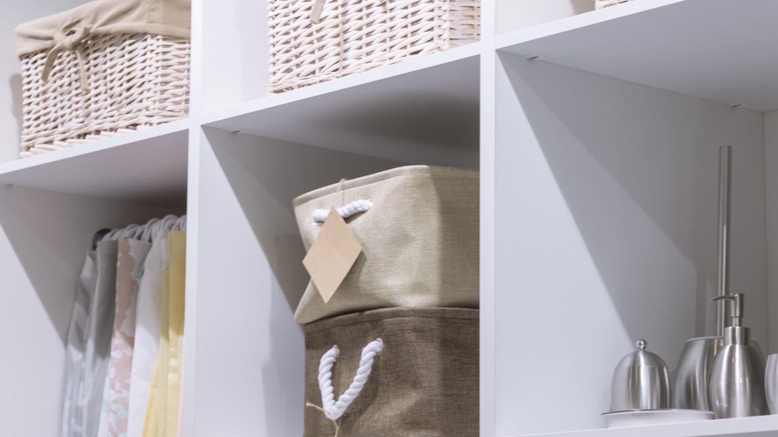 Organization of home space and order in the house. Baskets on a shelf in a closet. Clean room